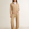 Pantaloni de jogging pentru femei, de culoare bej deschis, cu logo alb Pantaloni de jogging pentru femei, de culoare bej deschis, cu logo alb