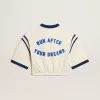 Tricou scurt din bumbac alb îmbătrânit, cu inscripție pe spate Tricou scurt din bumbac alb îmbătrânit, cu inscripție pe spate
