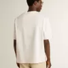 Tricou unisex alb cu imprimeu mediteranean și patch Pescheria Golden pe mânecă Tricou unisex alb cu imprimeu mediteranean și patch Pescheria Golden pe mânecă